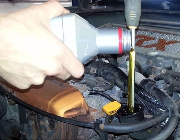 18. Finally, if you need to top up your engine oil but don't have a funnel, use a screwdriver or your dipstick and let the oil run down without spillage: