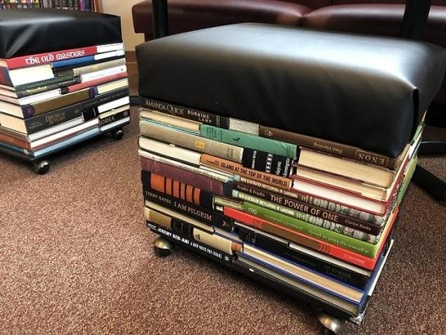 13. “Had a volunteer help me make these stools out of our discarded books for new library seating.”