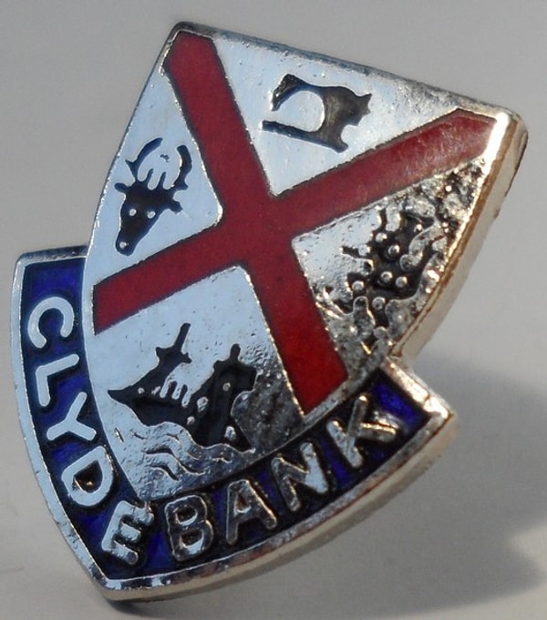 11. А в этом гербе наверху есть даже швейная машина - из какой он страны?