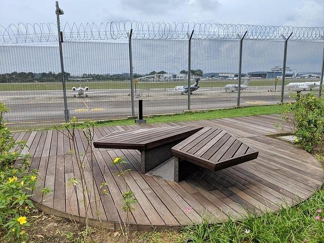 1. A paper plane shaped bench in an airport.