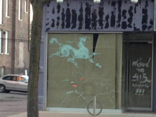15. “I found this smeared paint on the window of a vacant store that looks like a classical Chinese watercolor painting of a horse.”