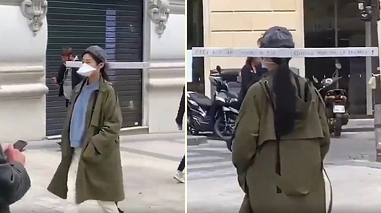 Женщина гуляет на улице с палкой на голове, чтобы не подпускать близко людей