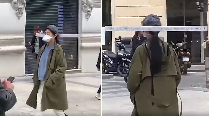 Женщина гуляет на улице с палкой на голове, чтобы не подпускать близко людей