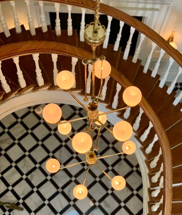 Ярусная латунная люстра в центре холла и витражный купол
