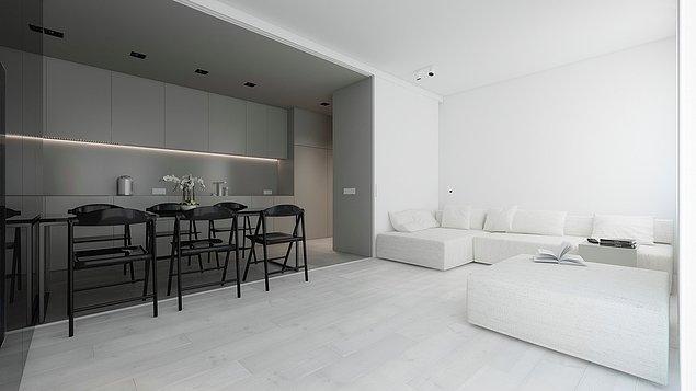 3. Mutfak ve salonu birleştiren bu minimalist tasarımda ise iki bölümü birbirine bağlamak için açık gri döşeme kullanılıyor.
