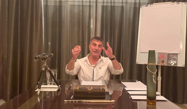 Son yayınlanan dokuzuncu videosunda masanın üstündeki dürbün, sandık, tesbih, kılıç kolyesi ve yine Mario Puzo kitapları dikkat çekiyor.
