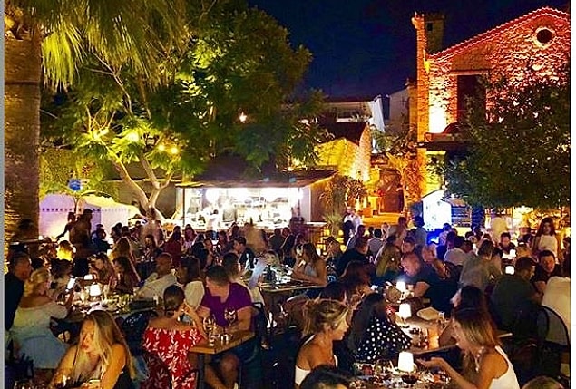 Rüzgarı ve havasıyla ünlü bu küçük ama popüler sahil kentinde 1 hafta bu şekilde takılmanın bedeli ortalama 15 bin TL. Yani hem Instagram tatil fotolarım güzel olsun, hem Acun gibi ünlüleri göreyim derseniz bu bedel cebinizden çıkacak gibi görünüyor. Bu paranın içinde kendini beğenmiş işletmelerin size uygun gördüğü manasız hesaplar, yoğun bir insan kalabalığı ve trafik de var. Elbette bu tatil tarzından çok daha müstakil takılıp, daha az para harcamak mümkün ama Alaçatı sizden bu parayı almak için de oldukça gayretli.