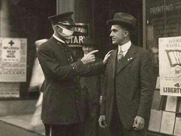 1. "San Francisco'da bir polis memuru, 1918 Grip Salgını sırasında maske takmadığı için bir adamı azarlıyor."