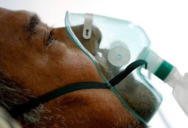 50. Willy Kurniawan'den Endonezya'nın Bogor kentindeki bir hastanenin izolasyon odasında bir COVID hastası solunum maskesi yardımıyla nefes alıyor.