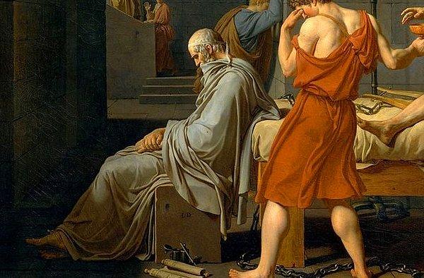 Yatağın ucunda üzgün bir şekilde oturan figür ise Platon'dur.