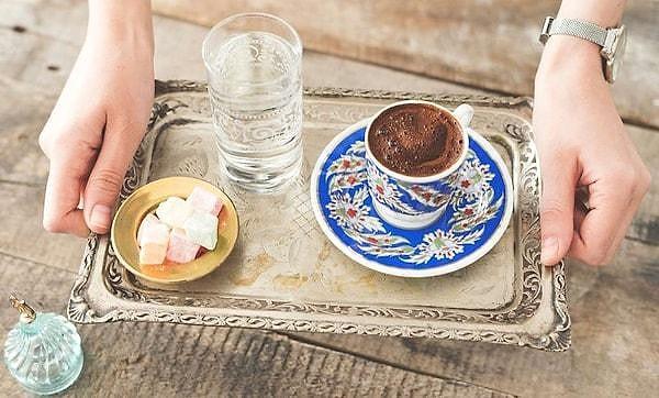 Turkish coffee is traditionally served in small cups, accompanied by a glass of water and a small sweet treat like Turkish Delight.