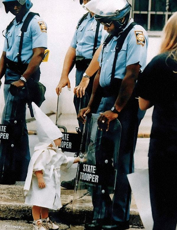 4. Siyahi bir eyalet polisi ve ırkçı bir eylemdeki küçük çocuğun kameralara yansıyan masum karesi.