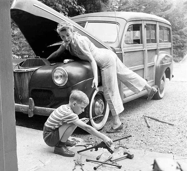 7. Eşi savaşta olan bir kadın çocuğuyla arabalarını tamir ederken. (1944)