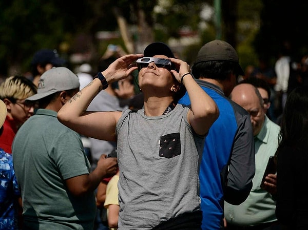 Specialized filtered glasses designed for eclipses or regular sunglasses are recommended for safely observing solar eclipses.