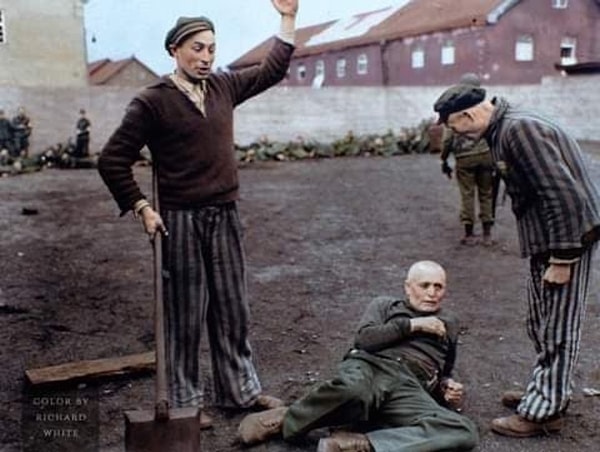 2. Former Dachau prisoners preparing to execute an SS guard with a shovel, while an American soldier can be seen in the background.