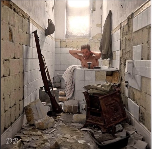 5. A soldier bathing in an abandoned house in Libya.