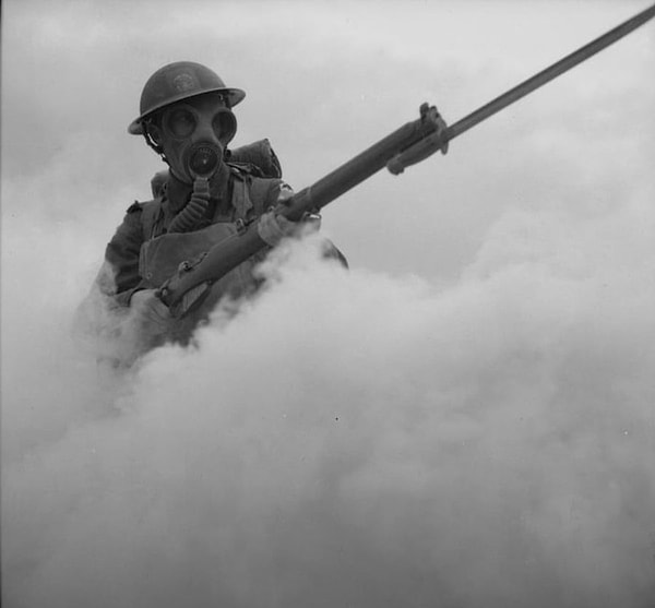 6. A British soldier advancing through a foggy landscape.