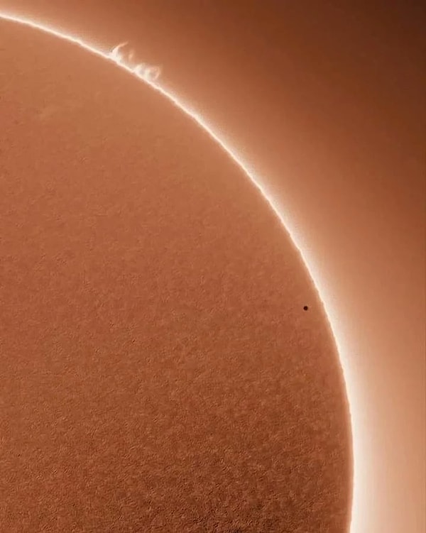 That tiny dot in front of the Sun is actually Mercury.