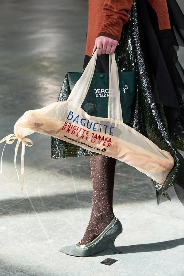 Following Love Moschino, UNDERCOVER took a similar approach with its semi-transparent baguette-shaped bags, adding a unique touch to the trend.