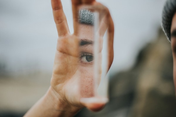 Traditional mirrors are made through a process called "silvering," where a reflective coating of tin, silver, or aluminum is applied to the back of a glass pane.