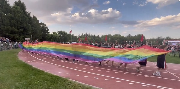 Metrelerce uzunluktaki bayrağa ve atılan sloganlara tribündeki katılımcılar da eşlik etti.
