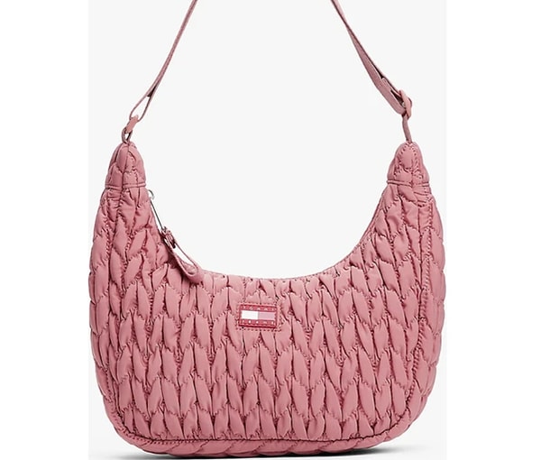 Tommy Hilfiger’ın TJW Urban X‑Body Quilted modeli, pembe kapitone yüzeyi ve hilal formundaki siluetiyle dikkat çeken modern bir crossbody çanta.