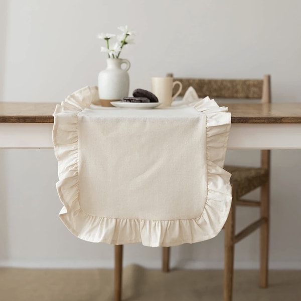 Sofralara romantik bir hava katan, fırfır detaylı keten dokulu runner.