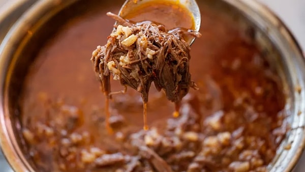 Beyran is a traditional soup from Gaziantep, Turkey, which is especially popular for breakfast. The soup is made from lamb meat and rice, and it's often served with a side of garlic and vinegar. The broth is rich and flavorful, and the meat is slow-cooked to perfection. The combination of the tender meat, hearty rice, and tangy garlic-vinegar sauce makes for a satisfying and delicious meal. Whether you're a local or a tourist, a bowl of Beyran is a must-try when you're in Gaziantep.