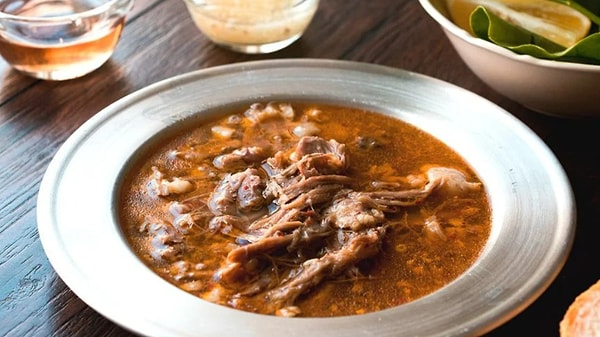 Beyran is a traditional soup from Gaziantep, a city in the southeastern region of Turkey. It's made from lamb meat and rice, and is typically served for breakfast. The soup is known for its rich flavor and is often enjoyed with fresh bread and a side of pickles. The preparation process is quite labor-intensive, as the meat needs to be cooked for several hours to achieve the desired tenderness. Despite the effort required, locals and tourists alike love the soup for its hearty taste and the warmth it brings, especially during the colder months.
