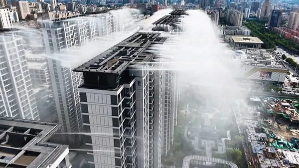 Mist is spreading like artificial rain from the tops of the buildings.