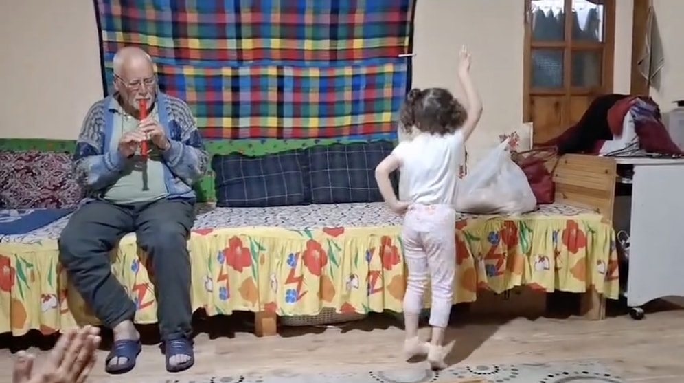 Pure Joy: Sweet Little Girl Warming Hearts While Dancing to Her Grandpa's Flute
