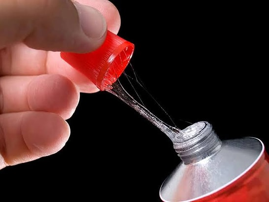Why Does Super Glue Leave a White Powder Stain Even Where It Does Not Touch?